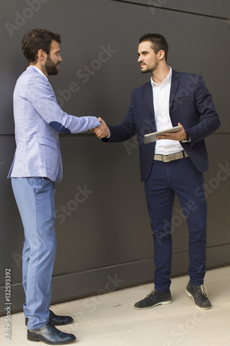 Young businessmen handshaki...