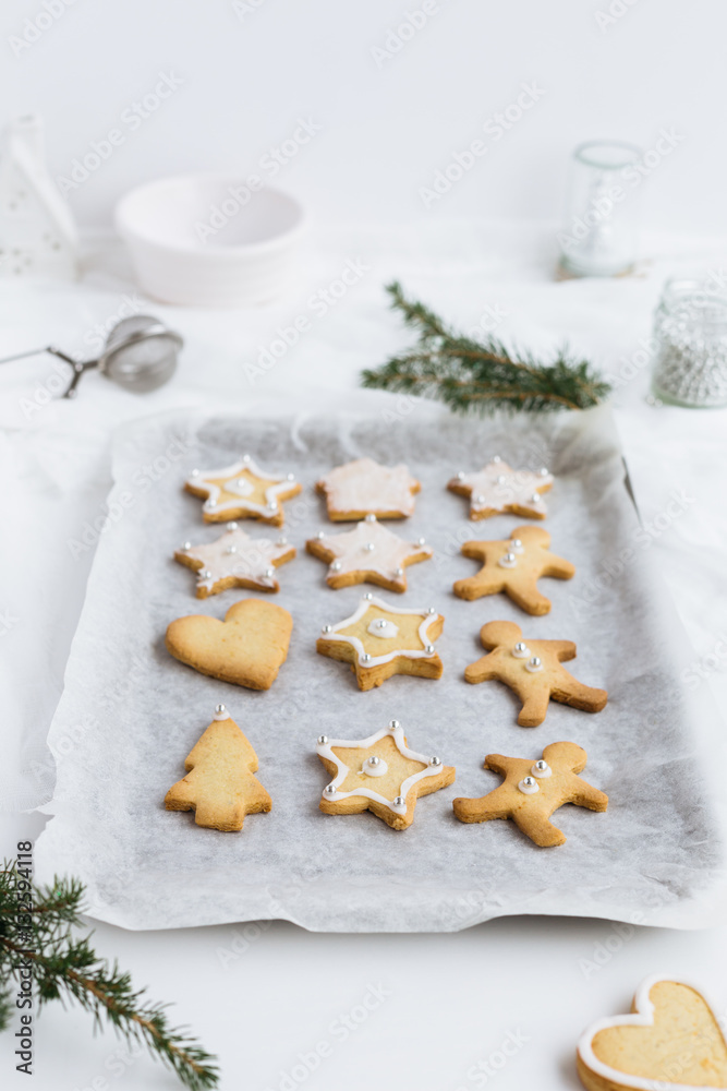 Fototapeta premium Vertical Food Scene of Festive Christmas Biscuits lined up on Baking Tray