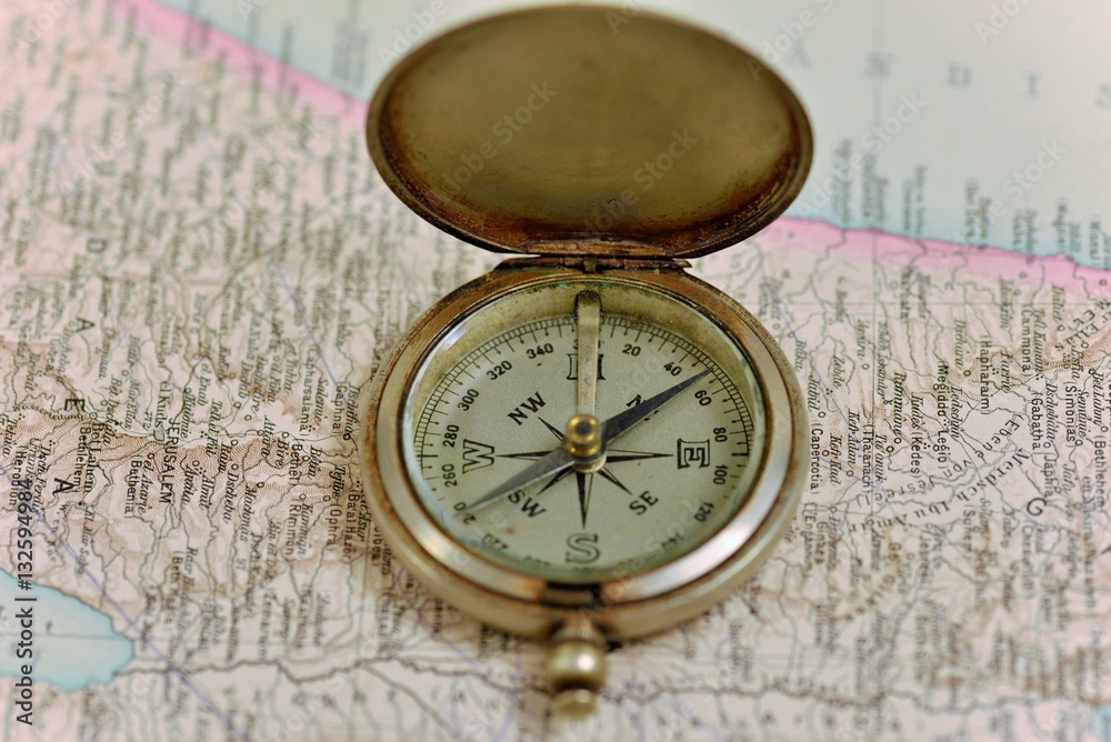 Old compass on the background of old maps Old compass on the background of old maps