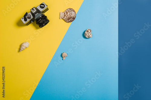 Top view of colorful, graphical sandy beach with summer accessories and copy space around products. Blank mock up for advertising or packaging. Colourful frame with graphical backdrop photo