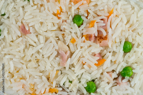 Meal background. Oriental rice dish with mixed meat, boiled egg, fresh vegetables like peas and carrot. Traditional Thai Food.