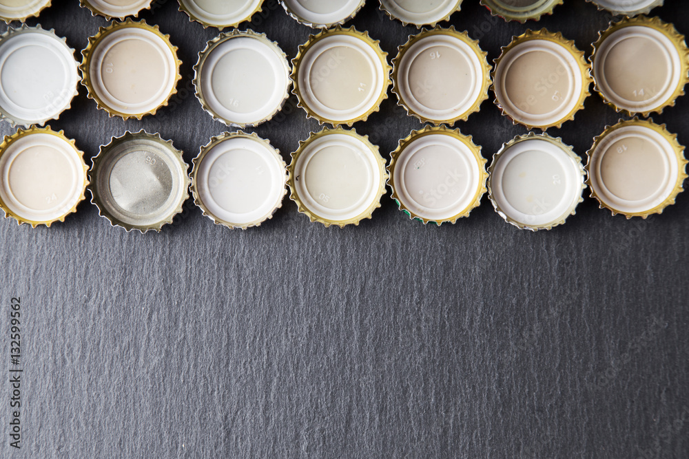 Cover of beer on slate blackboard, top view Cover of beer on slate blackboard, top view