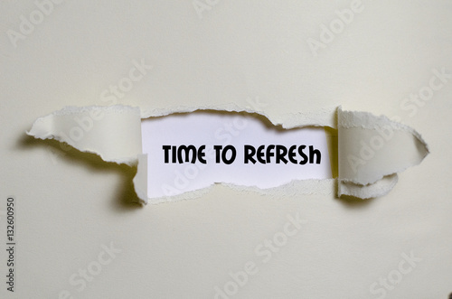 The word time to refresh appearing behind torn paper