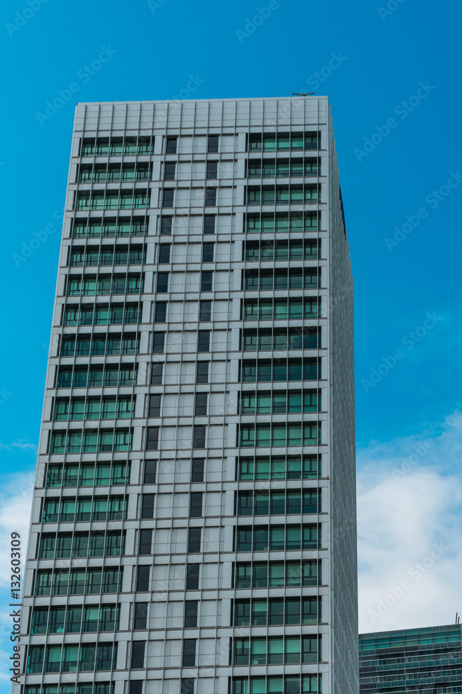 modern office skyscraper with clouds in the background modern office skyscraper with clouds in the background