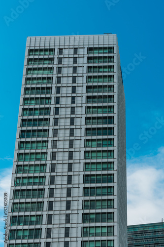 modern office skyscraper with clouds in the background