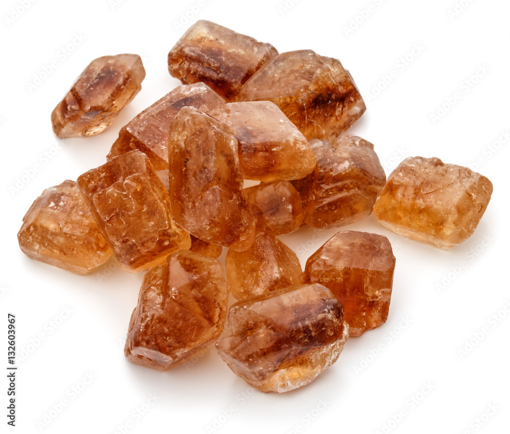 Brown caramelized lump cane sugar cube isolated on white backgro Brown caramelized lump cane sugar cube isolated on white backgro