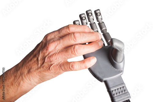 old woman's hand holding an artificial hand