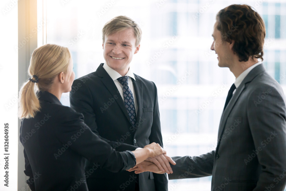 Group of business people, smiling, holding hands in a pile, managing and having control over the company together, personal liability, great hopes and expectations concept