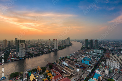 Sunset sky over Bangkok city river curved skyline background