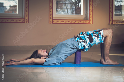 young man doing yoga indoor