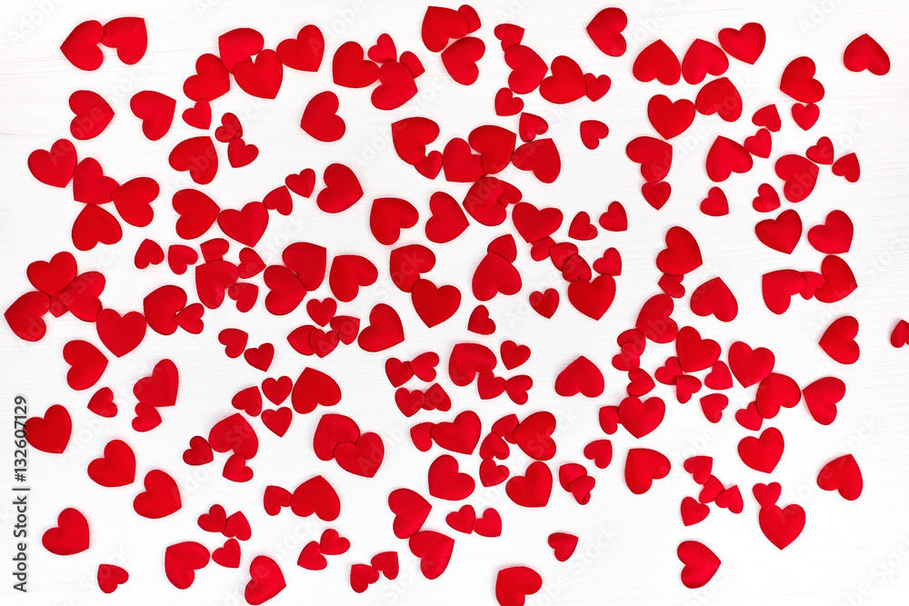 Valentines Day background with hearts. Red satin hearts on white wooden background Valentines Day background with hearts. Red satin hearts on white wooden background