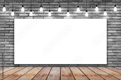 Blank white frame on brick wall and wooden with bulb lights lamp. nice brick show room with spotlights.