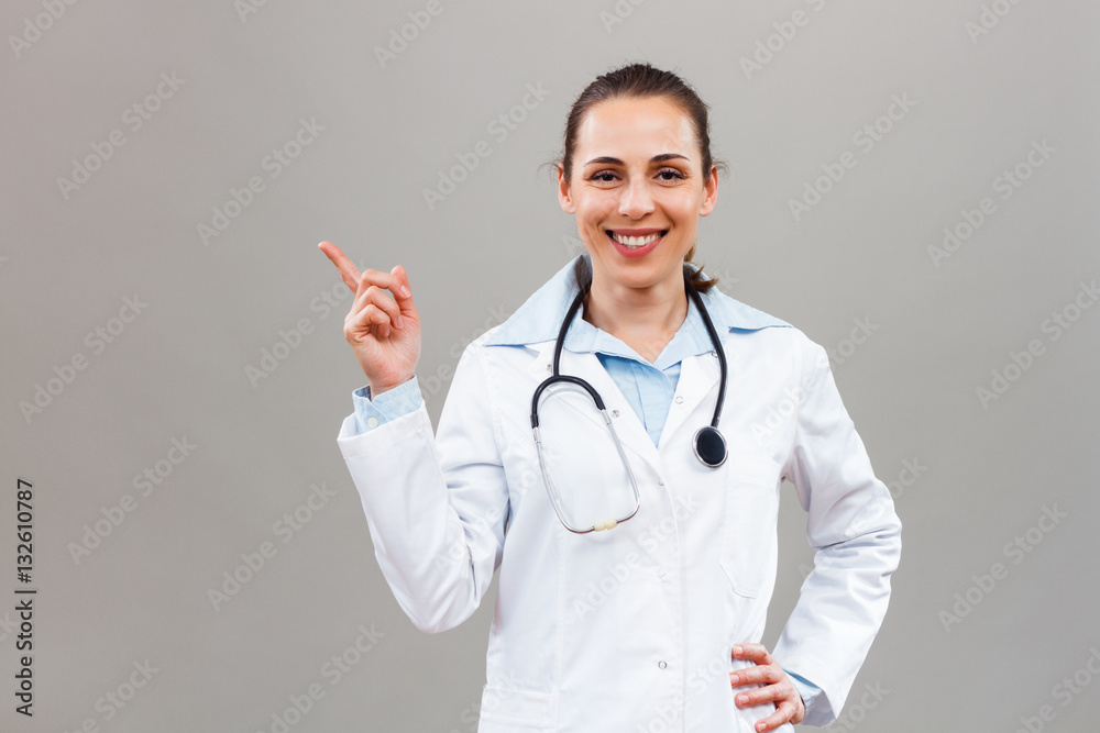Portrait of beautiful female doctor gesturing.
Portrait of beautiful female doctor gesturing.