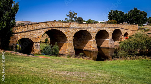 The iconic Richmond Bridge on bright sunny day. Richmond, Tasmania, Australia. Australia's oldest bridge made of stone was built in 1823