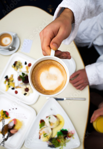 coffee cup in nahd at table photo