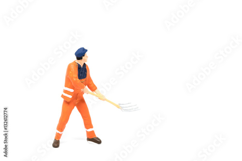 Miniature people worker wearing safety construction on white background