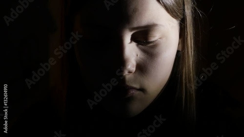 2Depressed teen girl is scared by something in the dark. 4K UHD.
