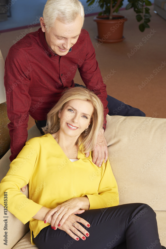 Spending time together. Shot of a lovely senior couple sitting on couch and relaxing together at their home. Spending time together. Shot of a lovely senior couple sitting on couch and relaxing together at their home.