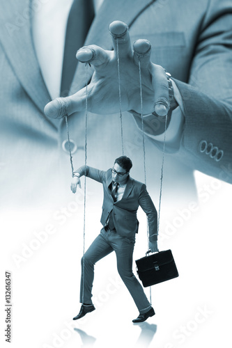 Businessman puppet being manipulated by boss