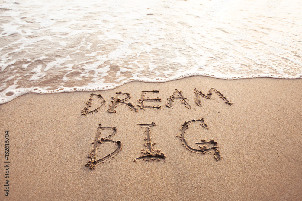 Fototapeta premium dream big, motivational sign on the sand of beach