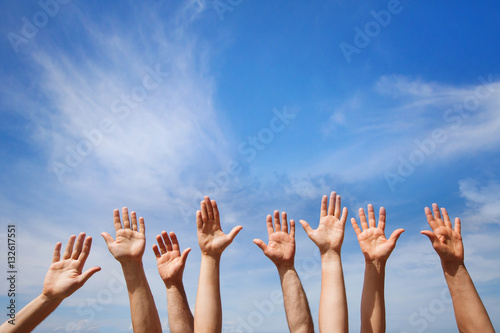 volunteering concept, hands of group of people volunteers in blue sky photo