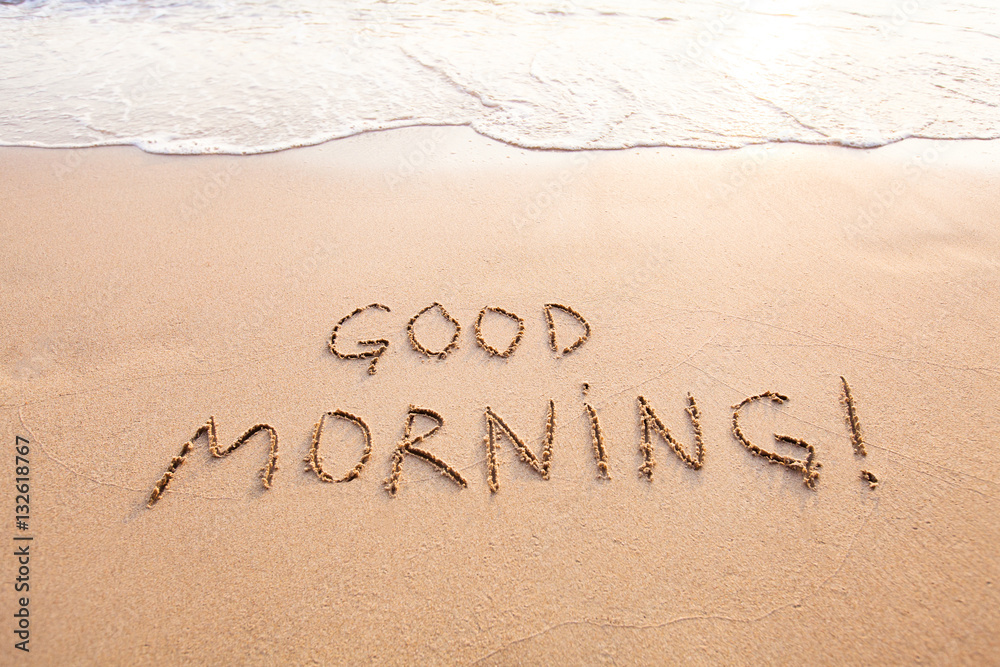 Fototapeta premium good morning, message text concept card, text written on sand beach