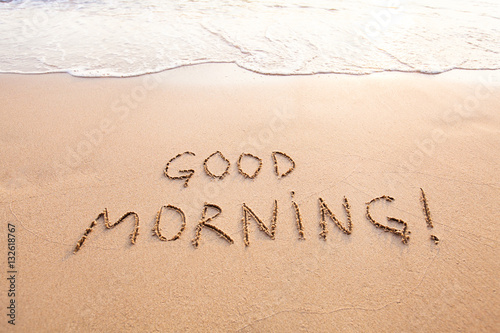 good morning, message text concept card, text written on sand beach