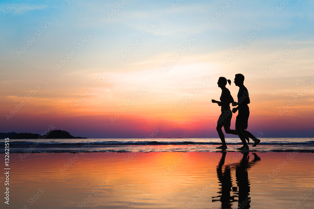 jogging and healthy lifestyle, two runners silhouettes on the beach at sunset, workout and sport jogging and healthy lifestyle, two runners silhouettes on the beach at sunset, workout and sport