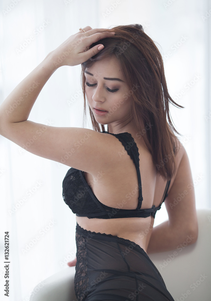Fashion shoot lingerie indoor .Sexy young girl in black lingerie in hotel.  Photos | Adobe Stock