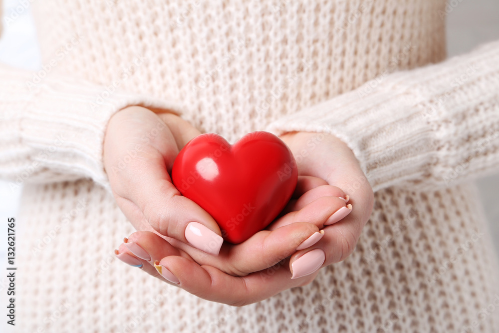 Woman holding red heart in hands Woman holding red heart in hands