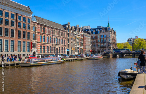 Traditional old buildings and and boats in Amsterdam, Netherlands