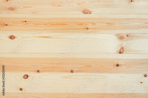 Fresh knotted pine wood planks background top view. Visible texture with natural patterns.