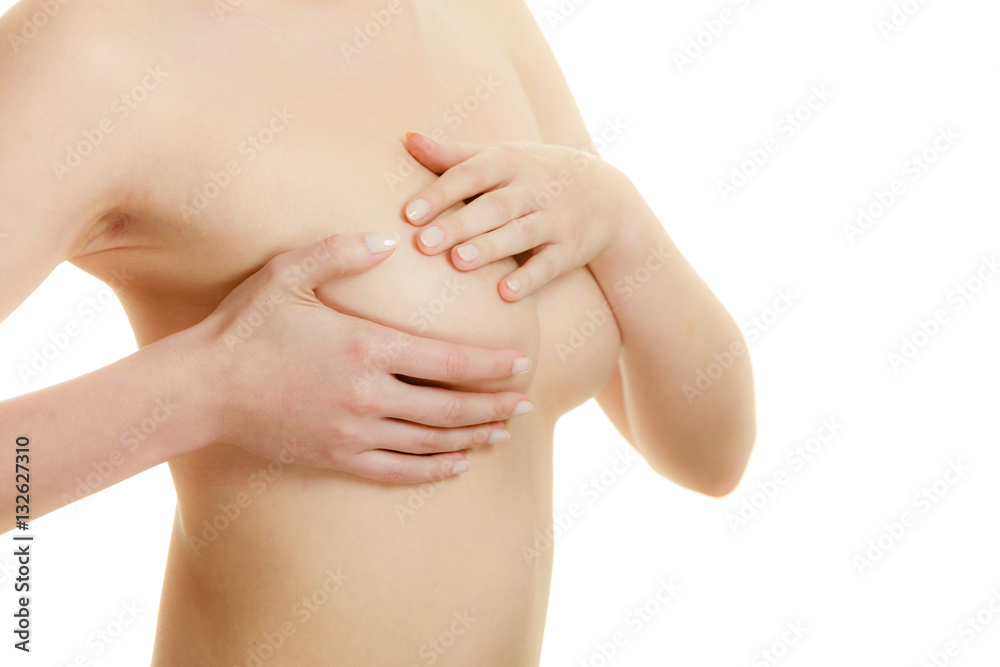 Woman examining her breasts for breast cancer