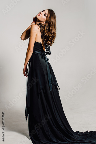 Individuality. Thoughtful Elegant Lady in Black Prom Evening Dress. Studio retouched photo.