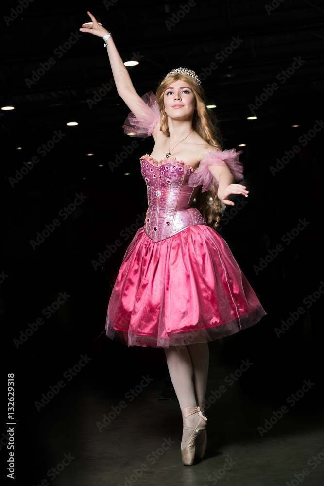 Young woman cosplayer wearing pink dress posing Young woman cosplayer wearing pink dress posing