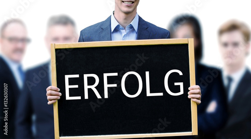 young businessman holding sign with german Success