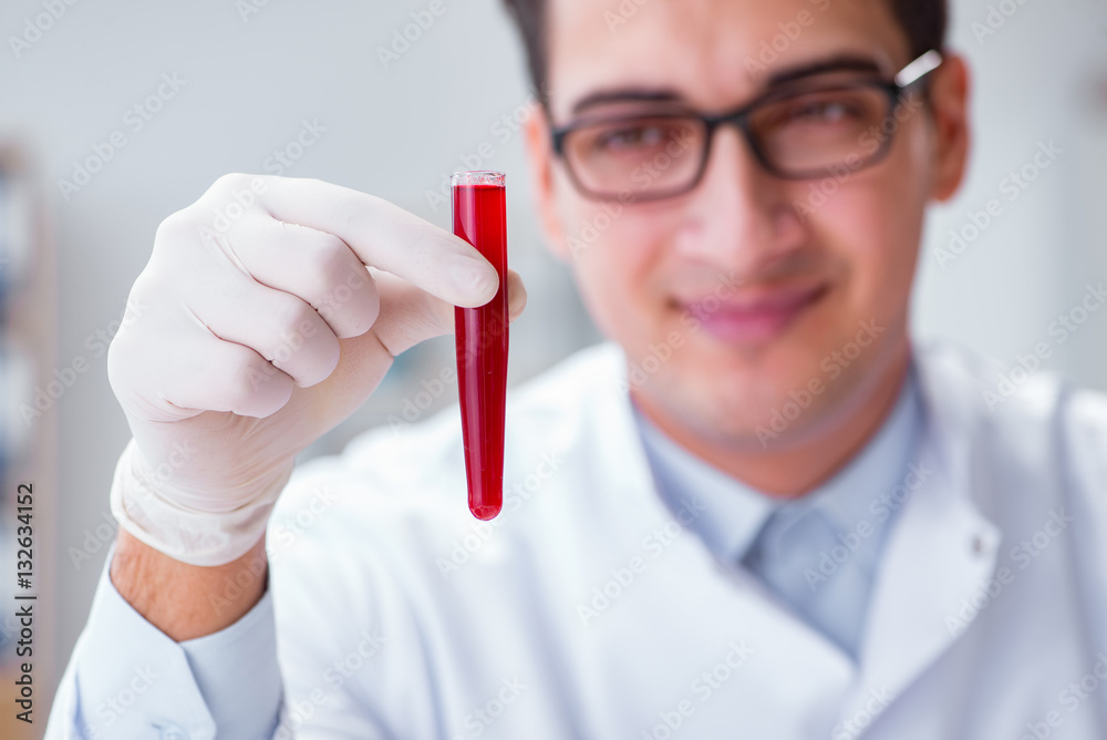 Young doctor in the lab with red tube Young doctor in the lab with red tube