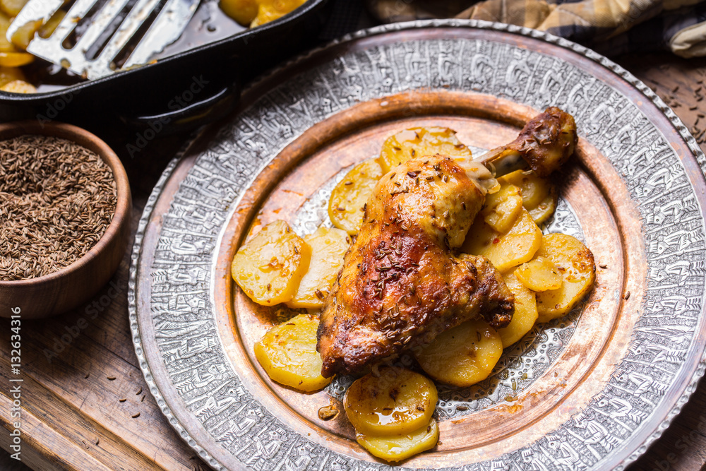Roasted chicken leg with potatoes with caraway and garlic. Roasted chicken leg with potatoes with caraway and garlic.