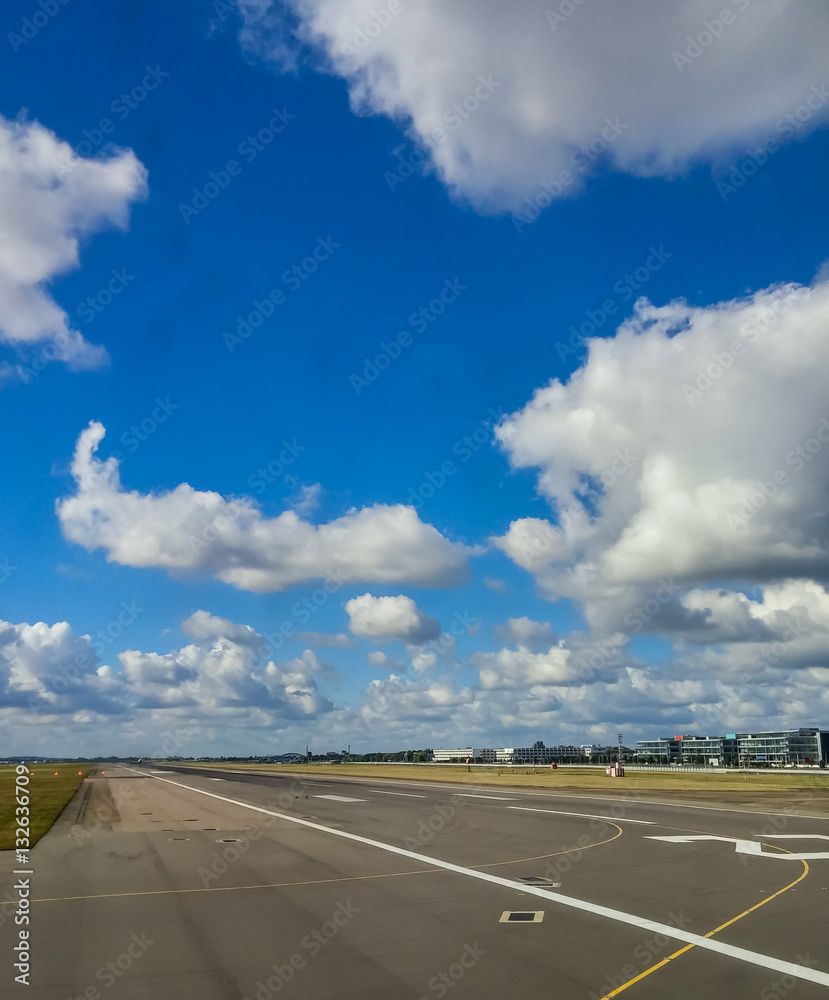 Fototapeta premium Runway Under Puffy Clouds