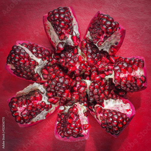 Garnet closeup sliced slices on a red background photo