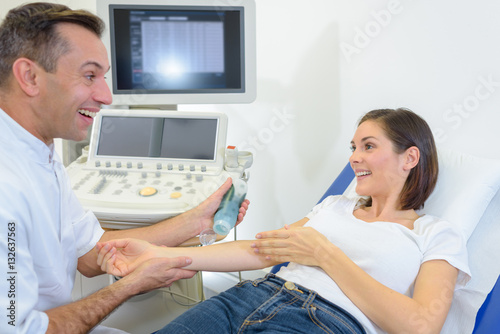 Doctor poised to scan patient's arm