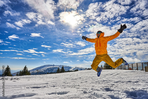 Man jumping on ski vacation
