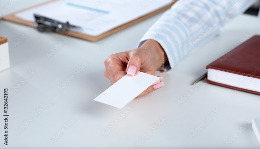 Businesswoman holding blank visit card ,sitting on the desk Businesswoman holding blank visit card ,sitting on the desk