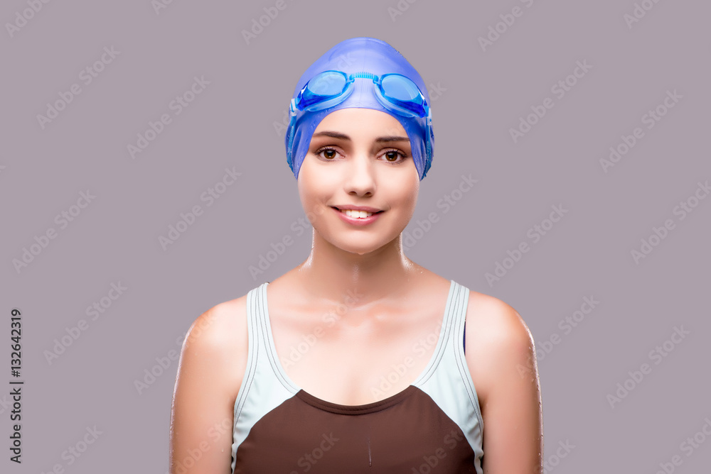 Woman swimmer against grey background Woman swimmer against grey background
