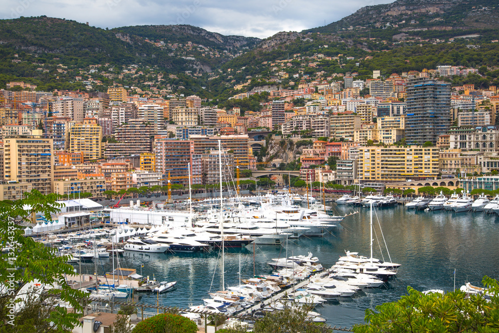 Principality of Monaco. View of the seaport and the city of Monte Carlo with luxury yachts and sail boats 
