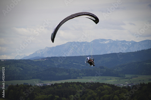 Paraglider flying in the panorama of the alps