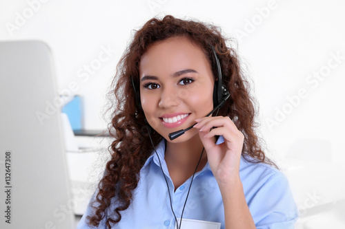 Young female technical support dispatcher working in office, closeup