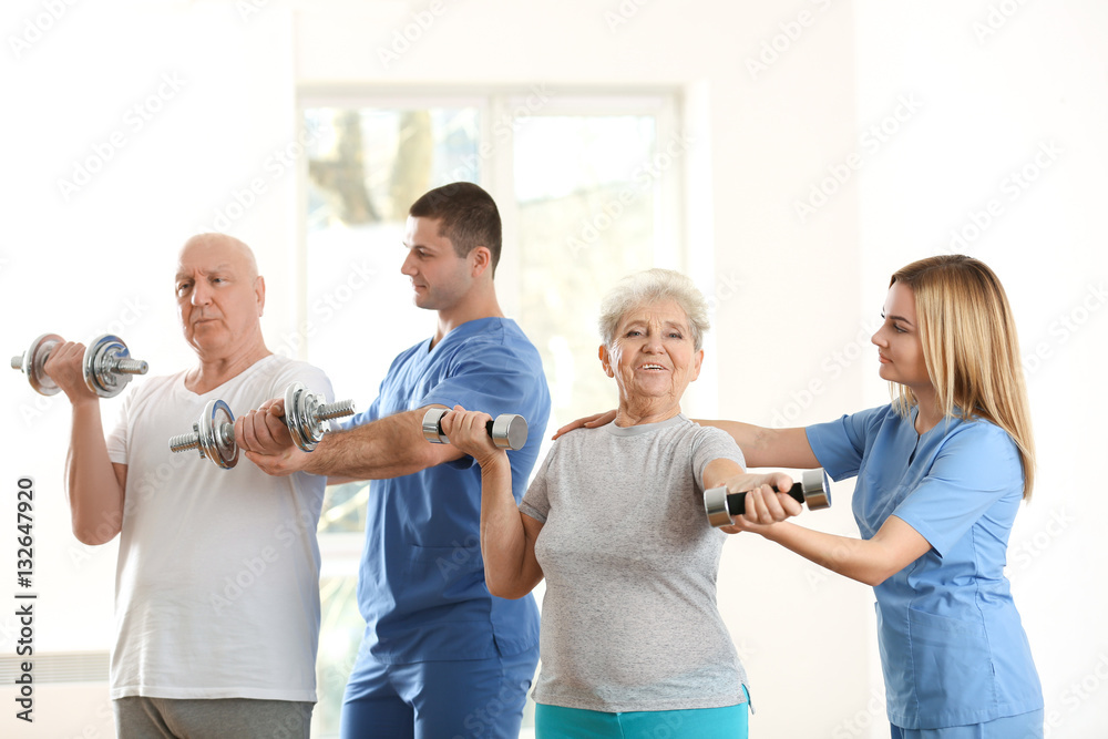 Physiotherapists working with elderly patients in clinic