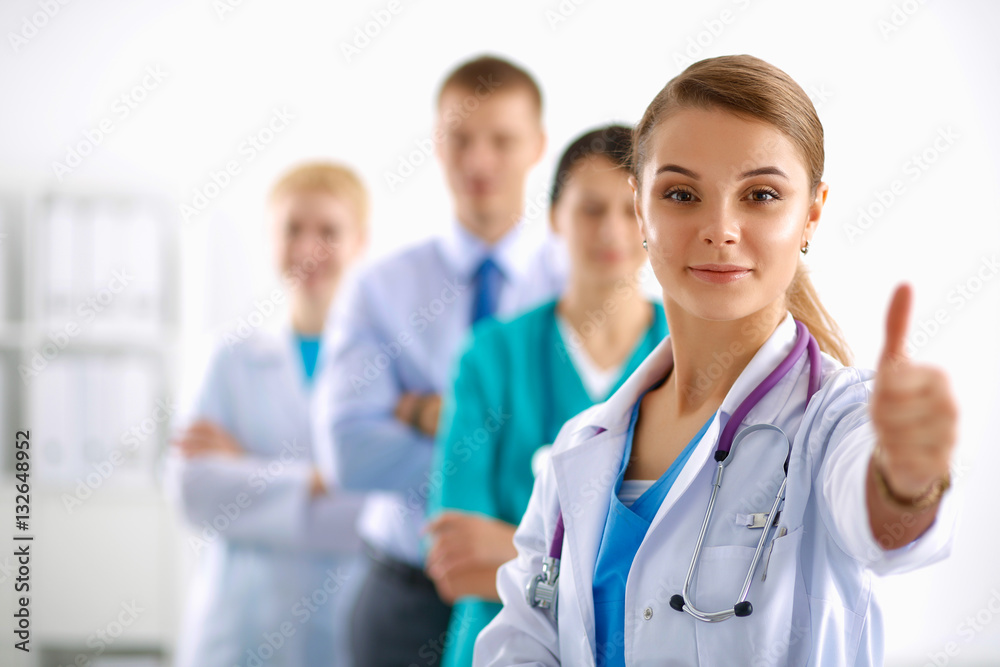 Attractive female doctor in front of medical group Attractive female doctor in front of medical group
