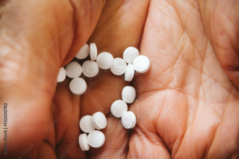 Pills in the palm of an old woman's wrinkled hands Pills in the palm of an old woman's wrinkled hands